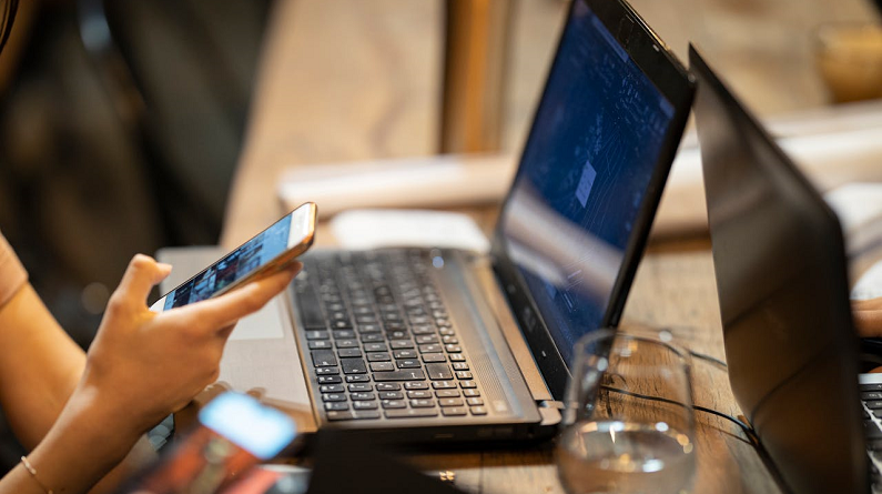 woman procrastinating by scrolling on her phone