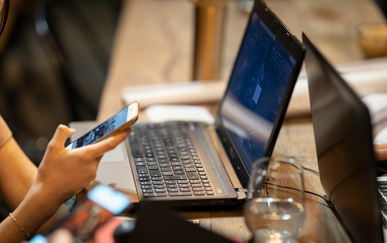 woman procrastinating by scrolling on her phone