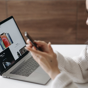 woman using smart phone and laptop at the same time