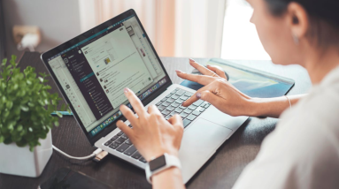 woman doing affiliate marketing on her laptop at home