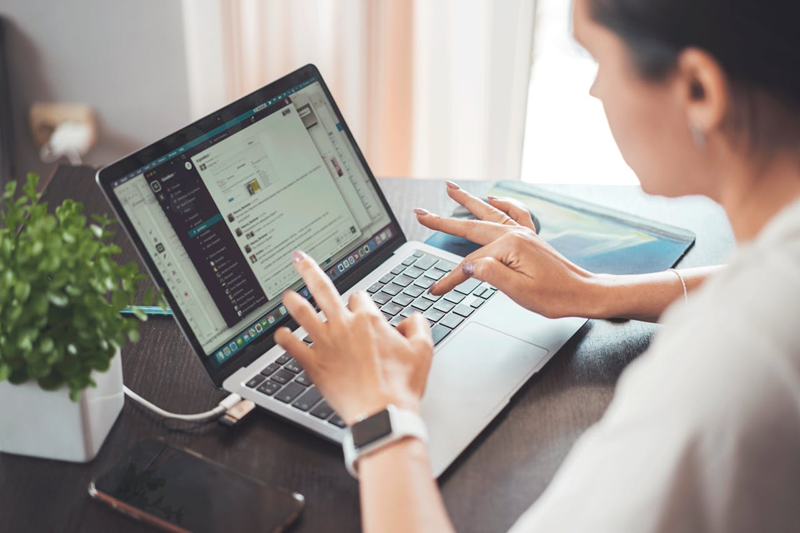 woman doing affiliate marketing on her laptop at home