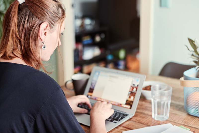 woman working online at home on her laptop