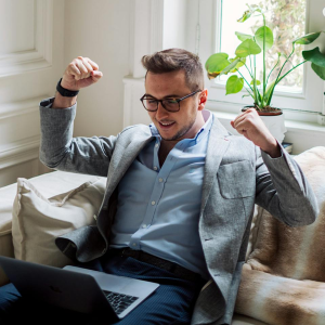 man working on laptop happy with the results he's getting