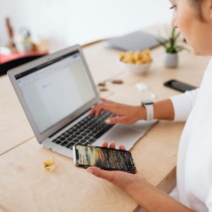 woman working online using laptop and smart phone