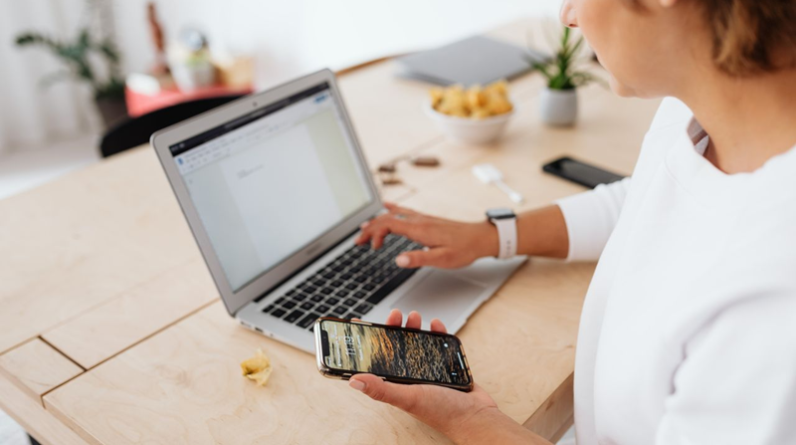 woman working online using laptop and smart phone