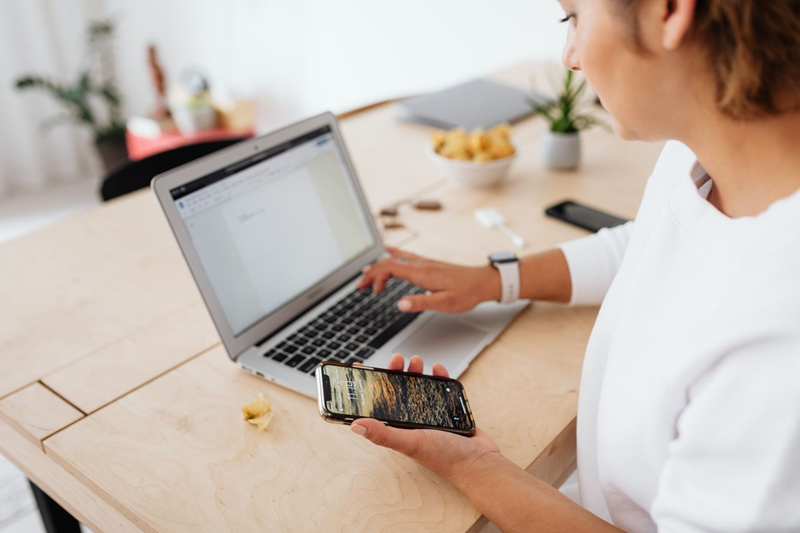 woman working online using laptop and smart phone